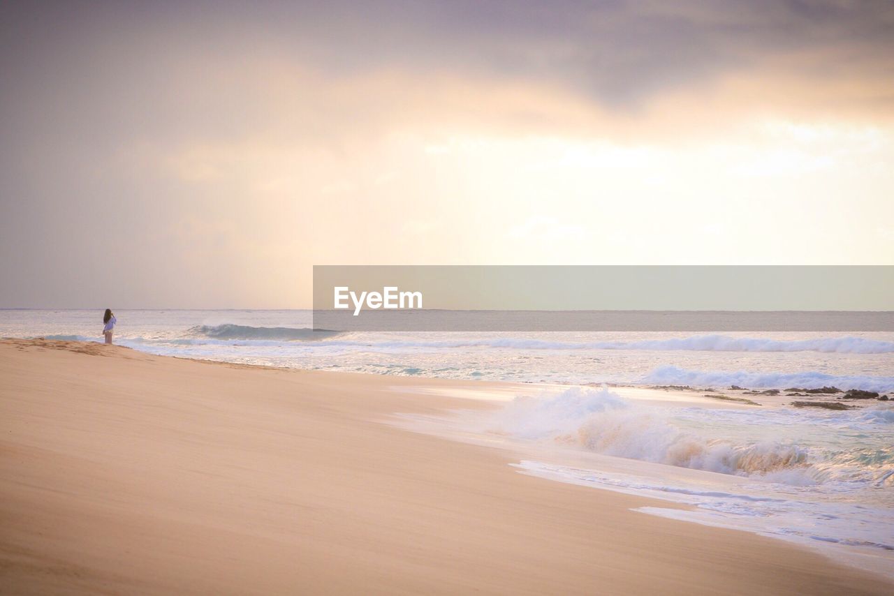 Scenic view of beach against sky during sunset