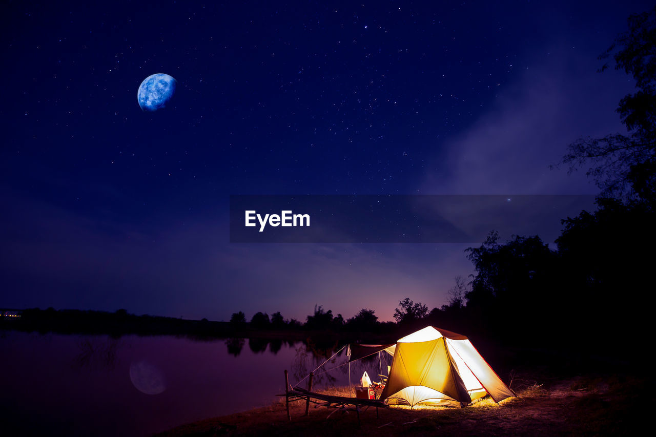 TENT AGAINST SKY AT NIGHT