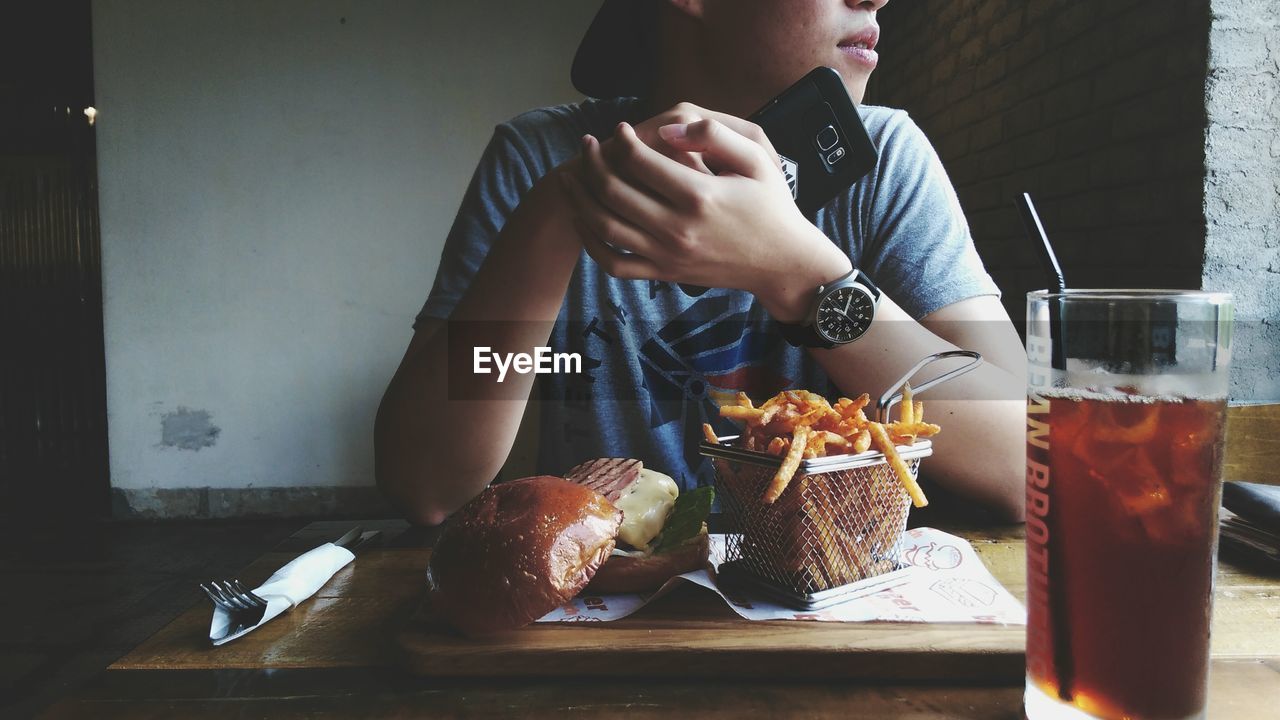 Man sitting by food at table