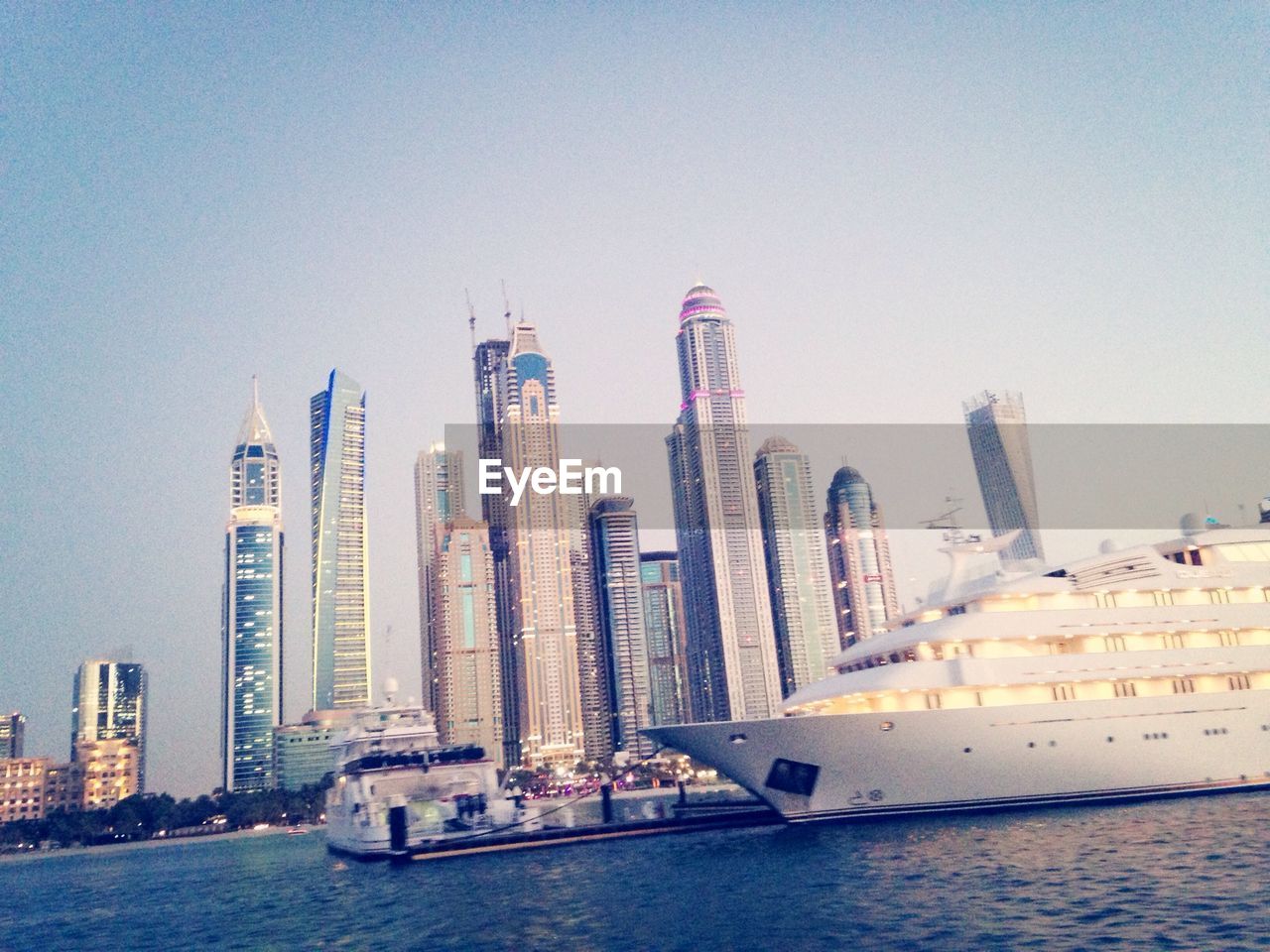 View of tall sky scrapers and yacht