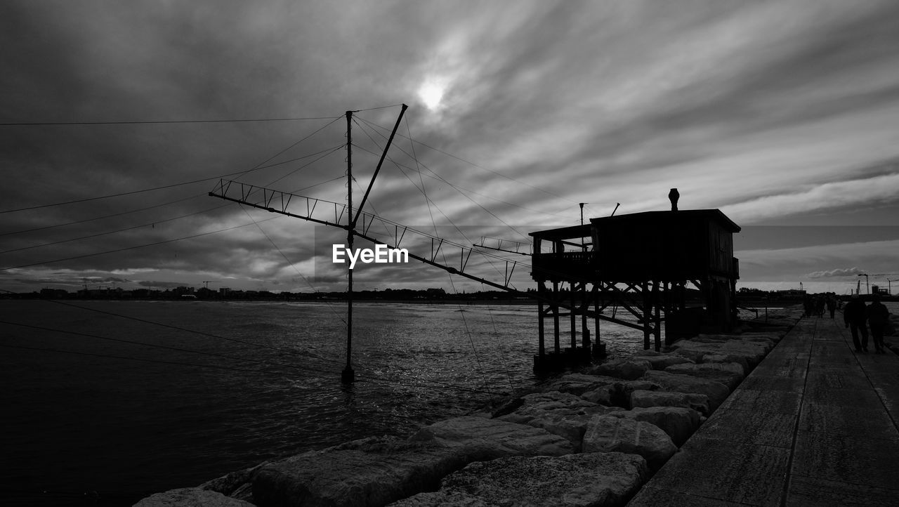 PIER ON SEA AGAINST SKY AT SUNSET