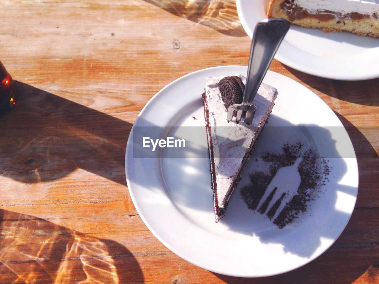 High angle view of chocolate cake slice served in plate with fork