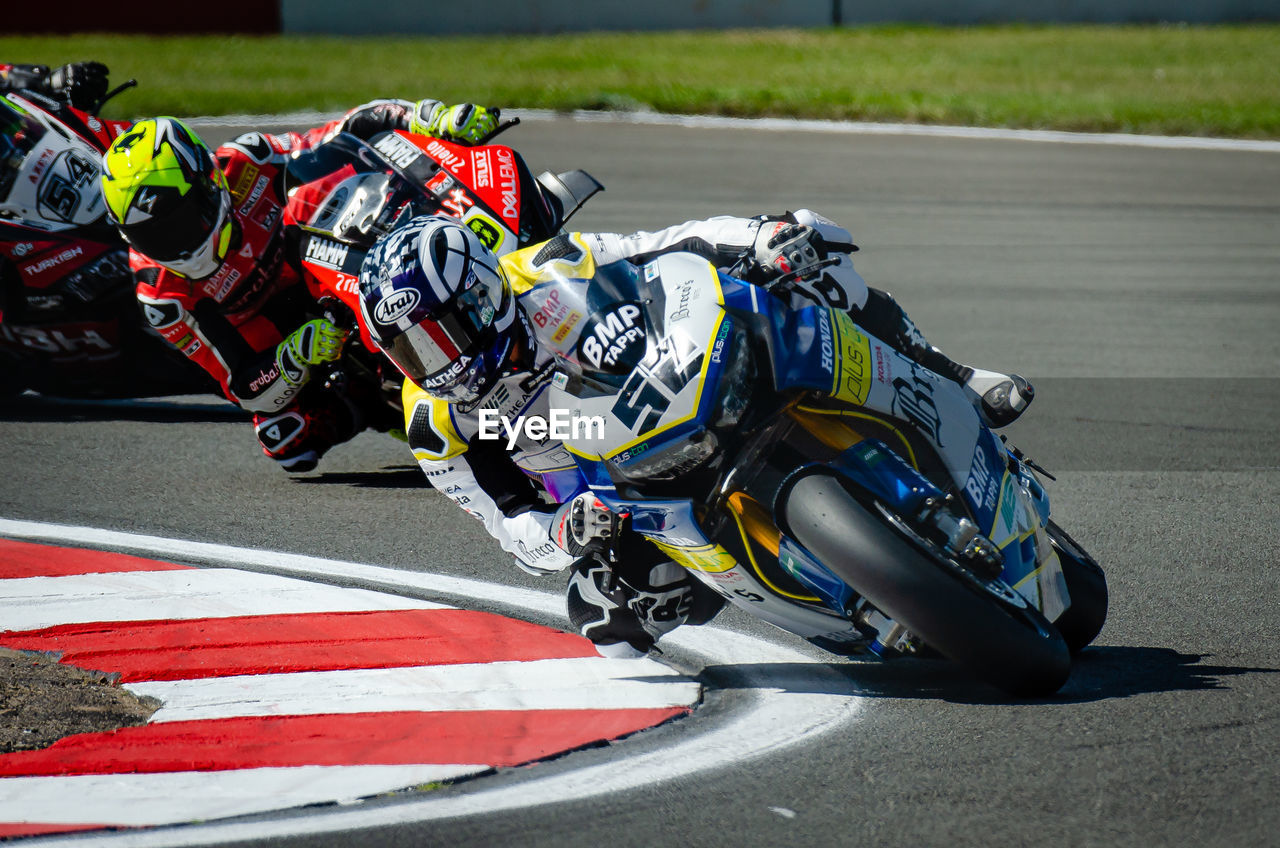 Men riding motorcycles in racing