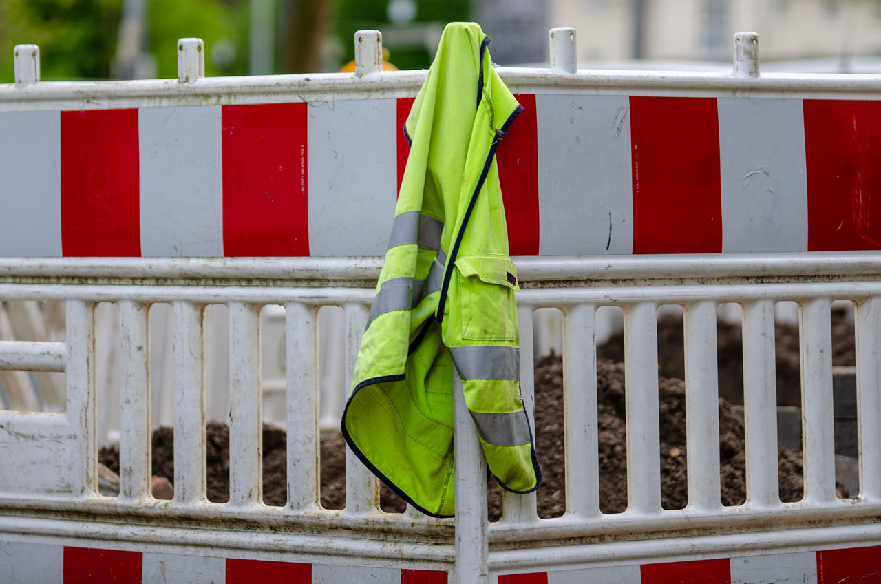 Close-up of reflective clothing on railing