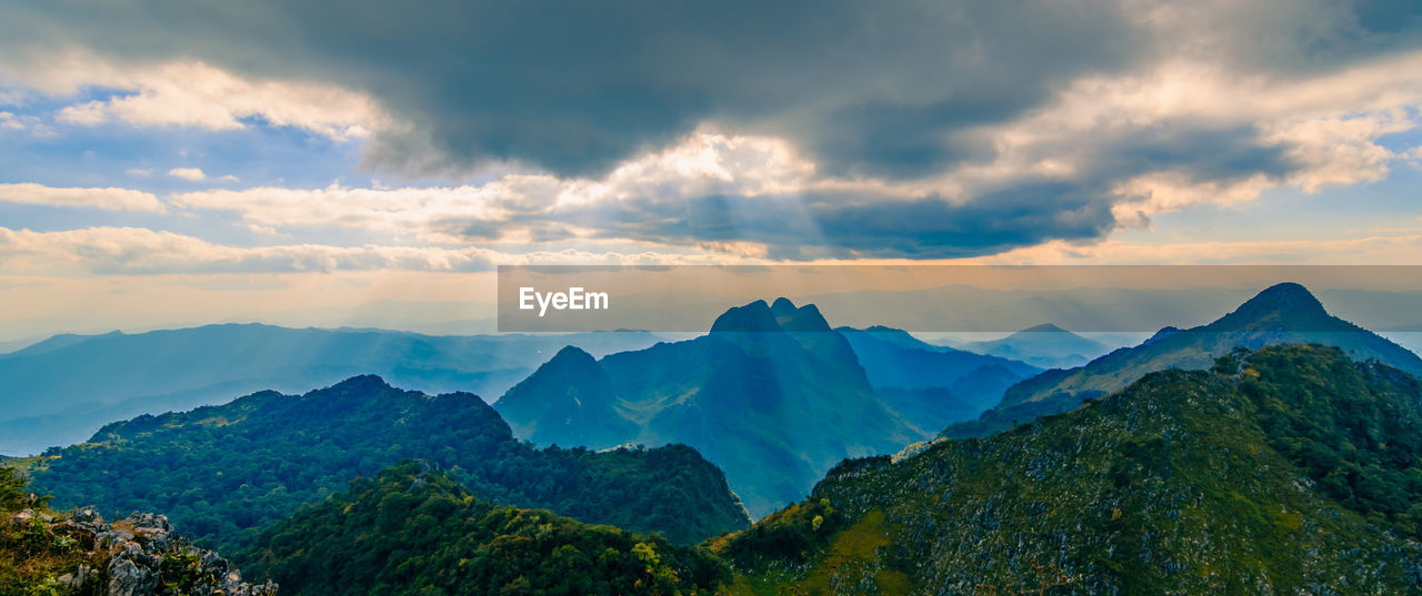 Panoramic beautiful scenic mountain range with blue sky, cloud and blast horizon sun