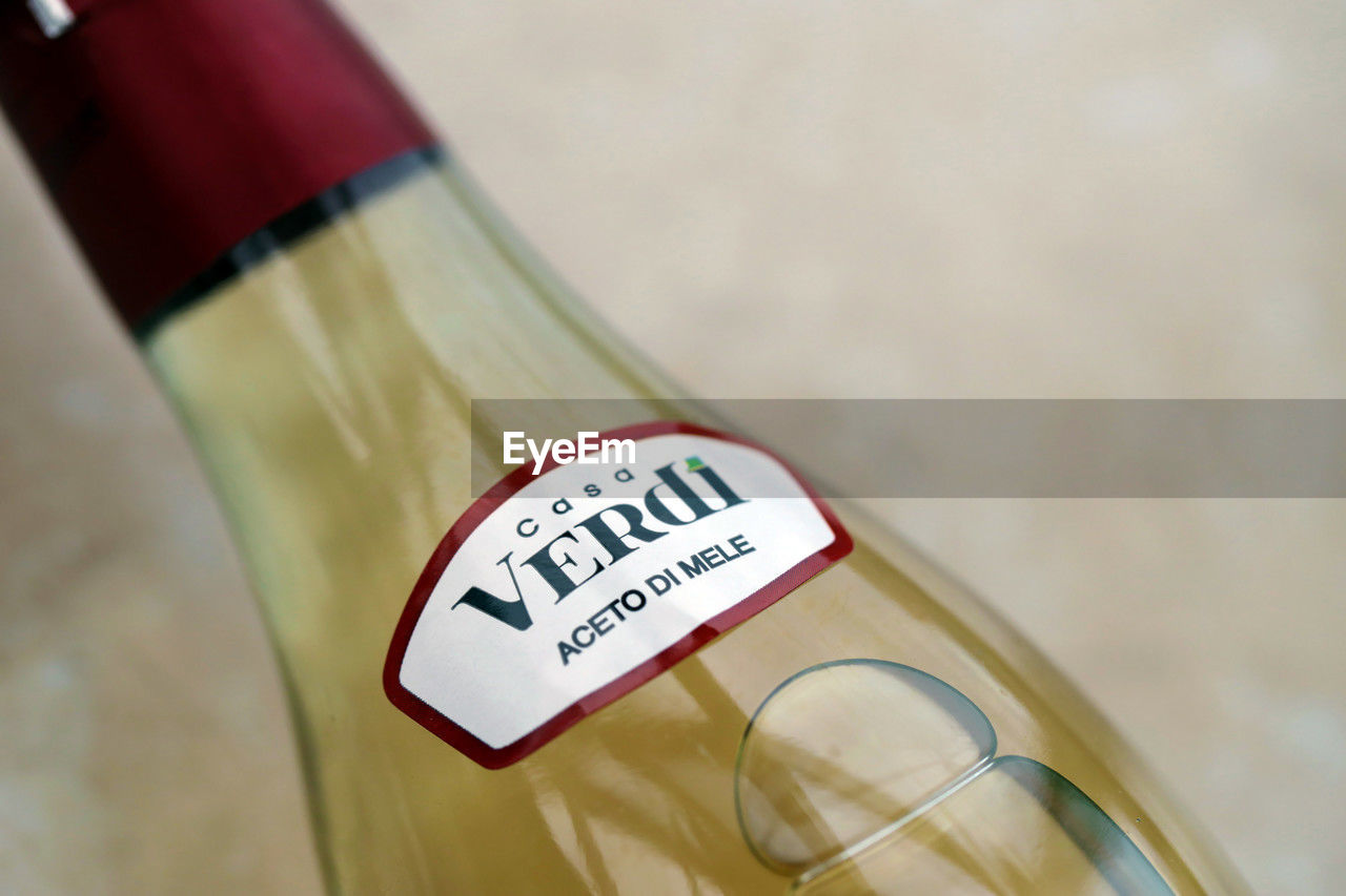 label, drink, text, alcoholic beverage, bottle, western script, no people, close-up, container, communication, indoors, food and drink, wine, wine bottle, refreshment, food, focus on foreground