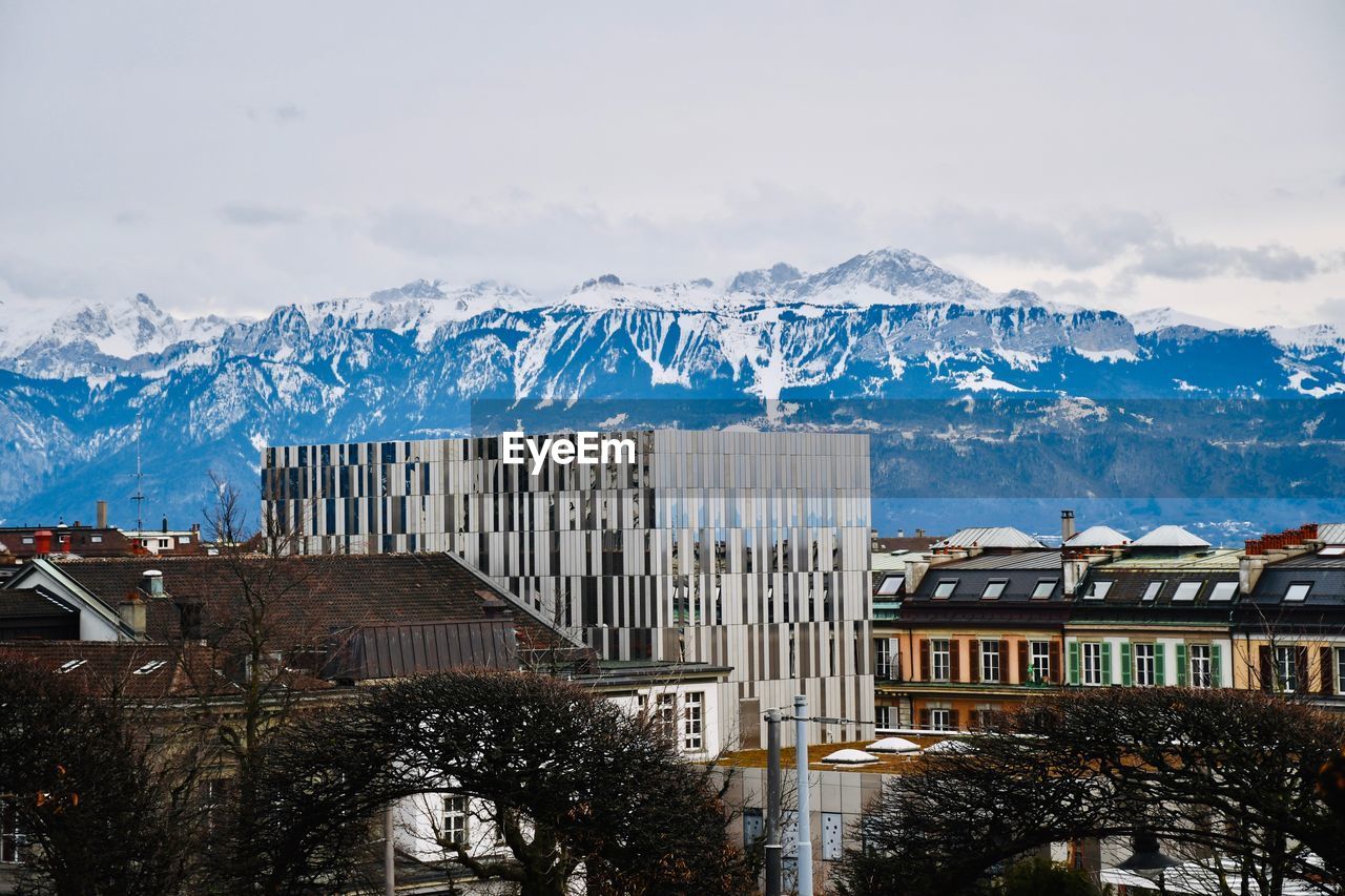 Buildings in city against sky during winter