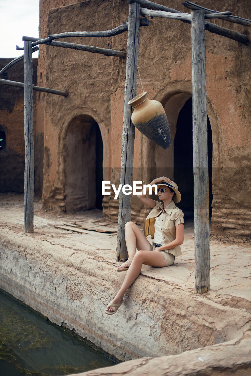 A traveler woman  is sitting in an old eastern city in the summer