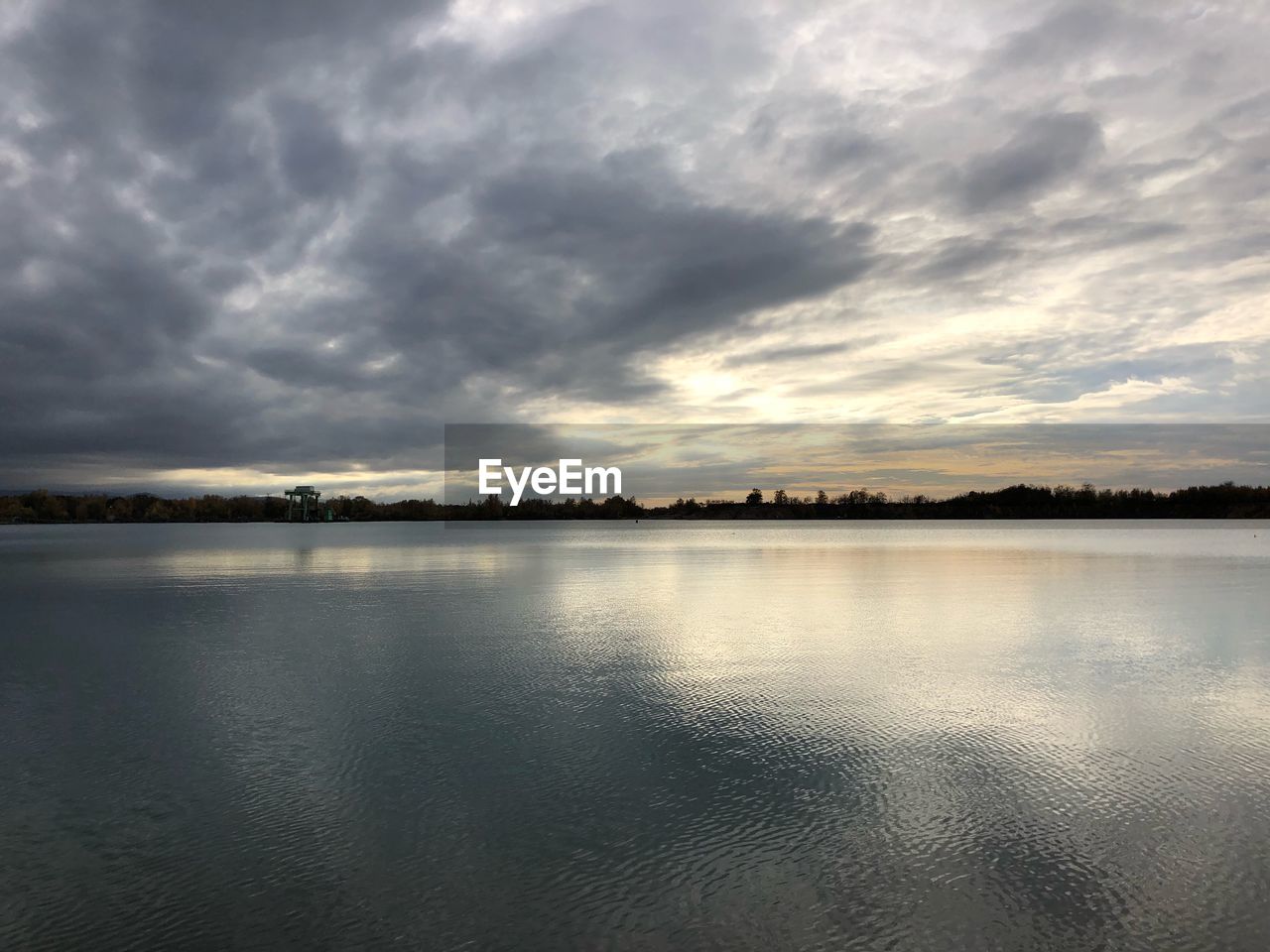 VIEW OF LAKE AGAINST CLOUDY SKY