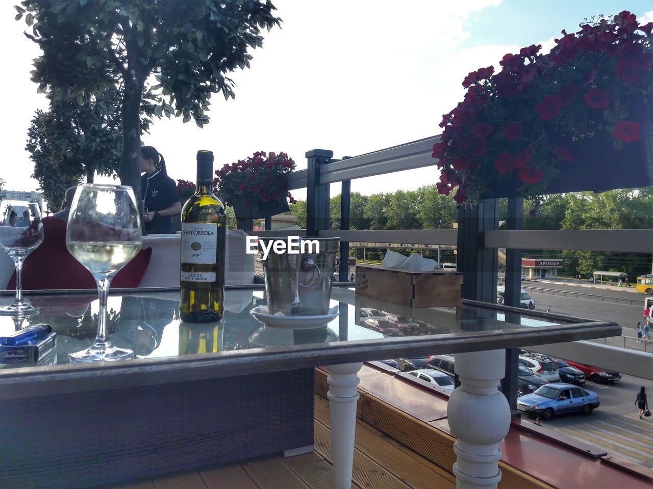 VIEW OF WINE GLASS ON TABLE BY RAILING