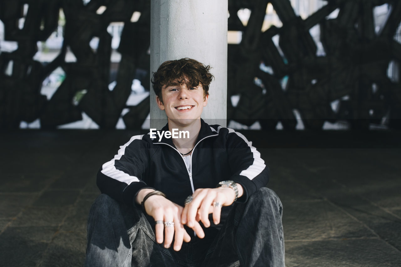 Smiling male teenager in parking garage