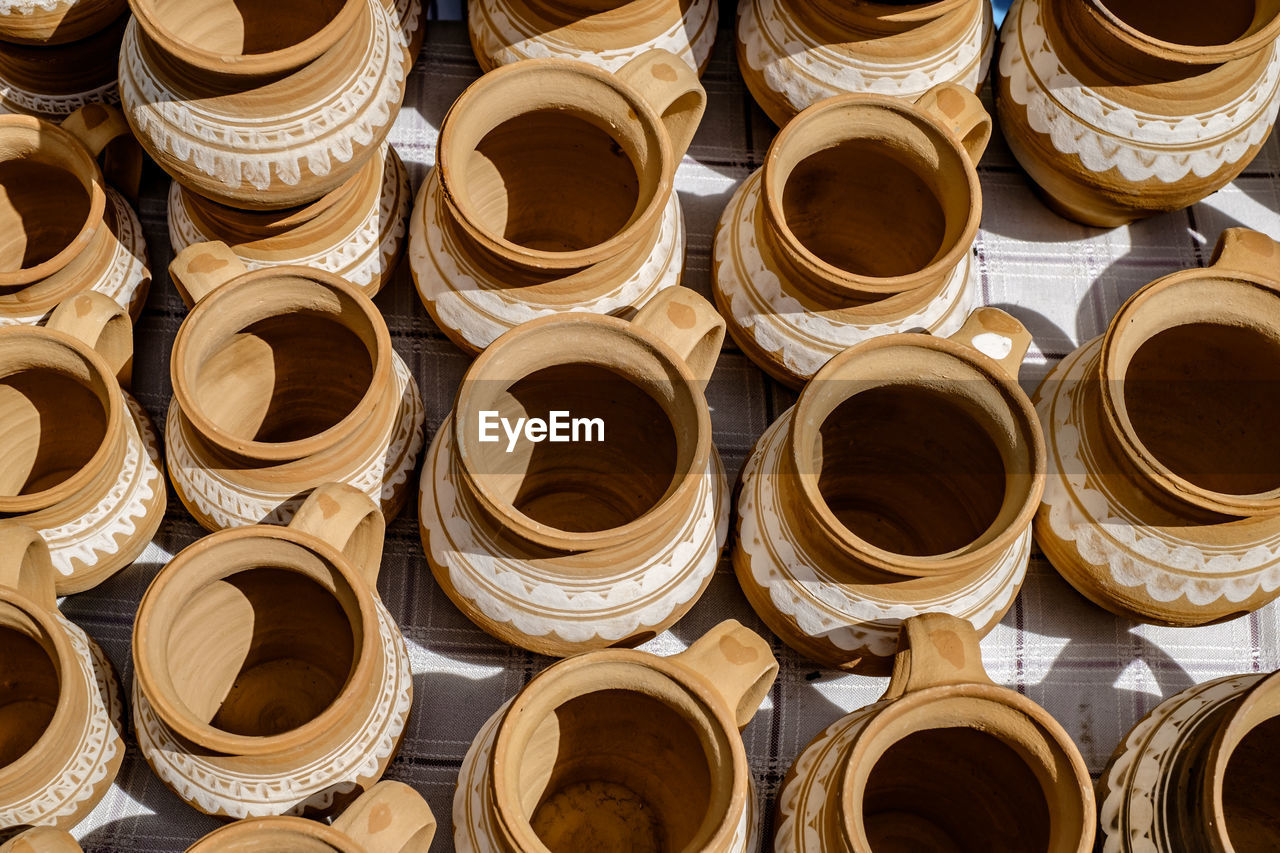 Unburned clay vessels on table