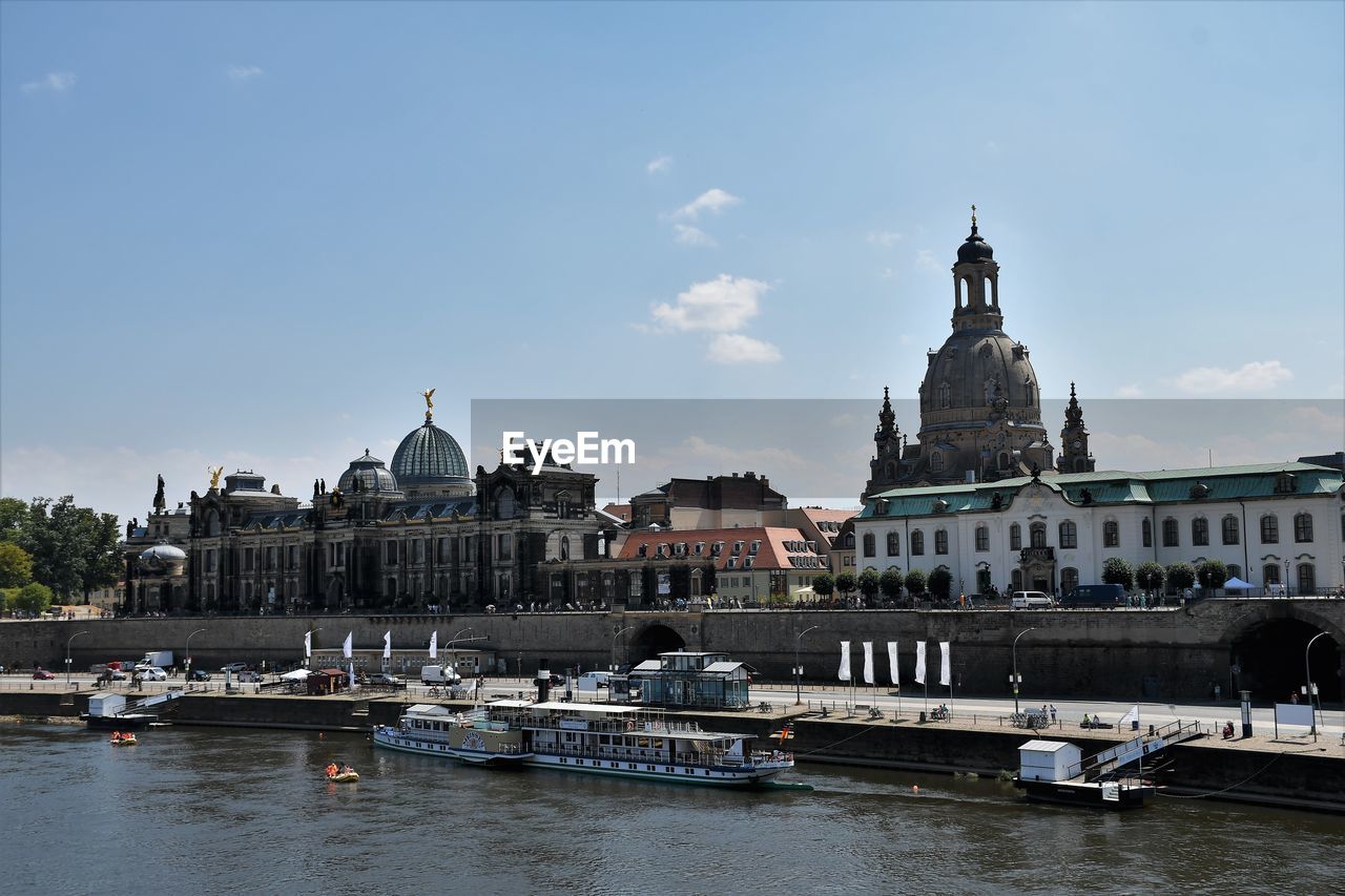 architecture, built structure, water, building exterior, travel destinations, nautical vessel, city, transportation, sky, travel, mode of transportation, river, nature, cityscape, building, tourism, religion, place of worship, ship, harbor, history, the past, vehicle, craft, waterway, boat, cloud, landmark, no people, day, waterfront, bridge, outdoors, belief, tower, reflection, watercraft, blue, government