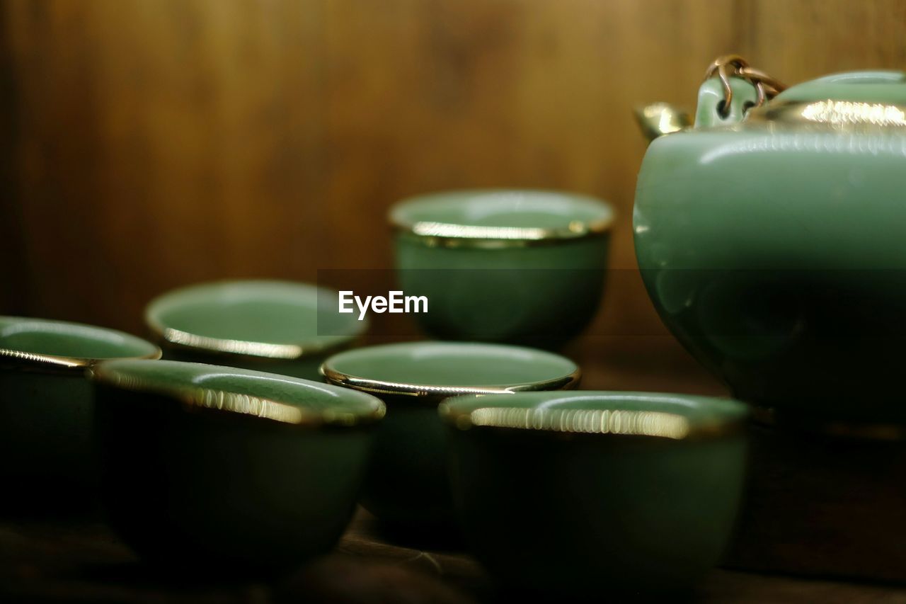 Close-up of green cups and kettle