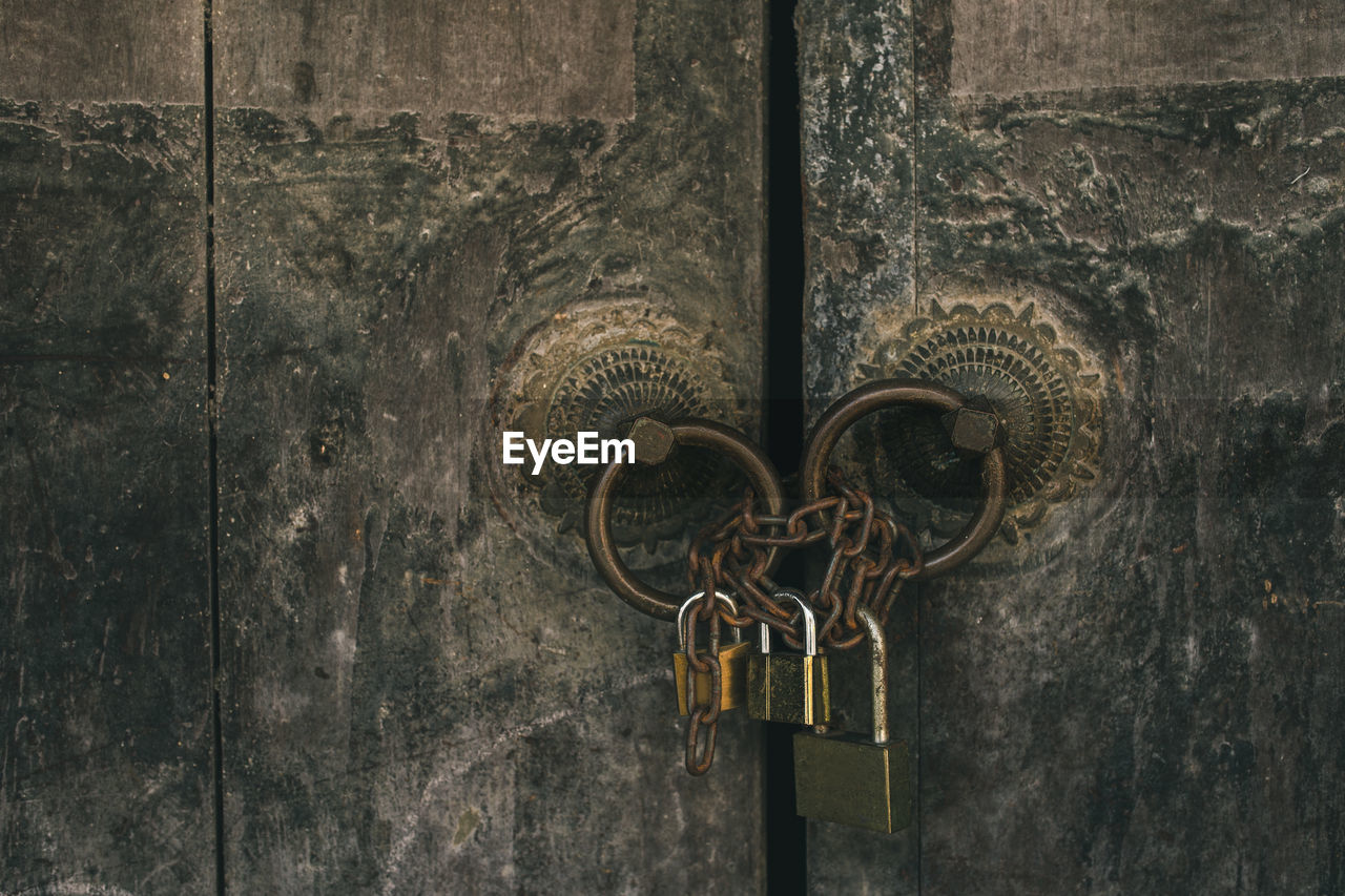 Close-up of padlock on metal door