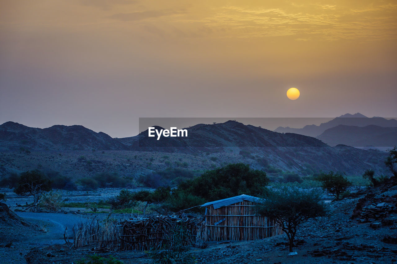 SCENIC VIEW OF LANDSCAPE AGAINST SKY DURING SUNSET