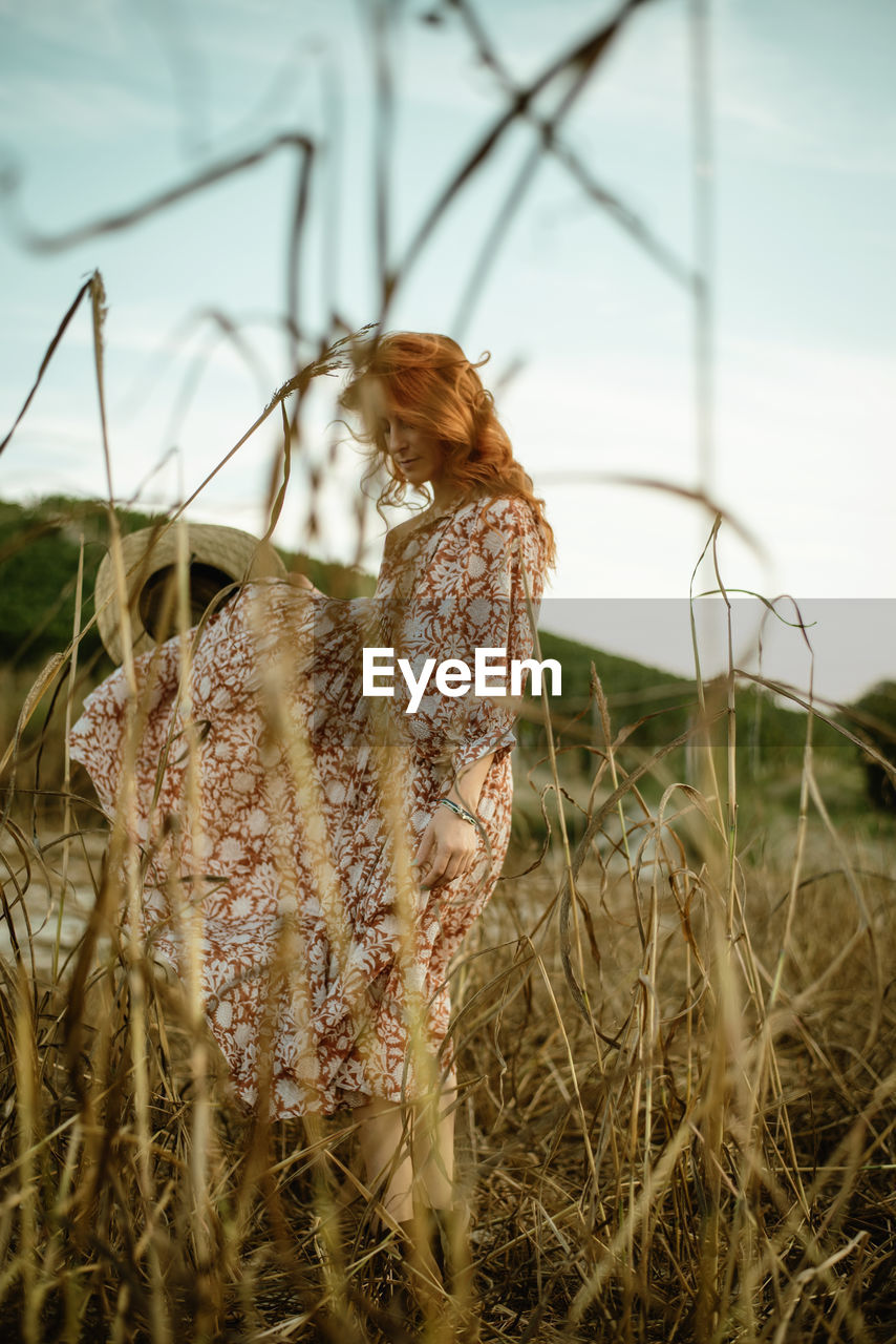 Redhead woman in a field