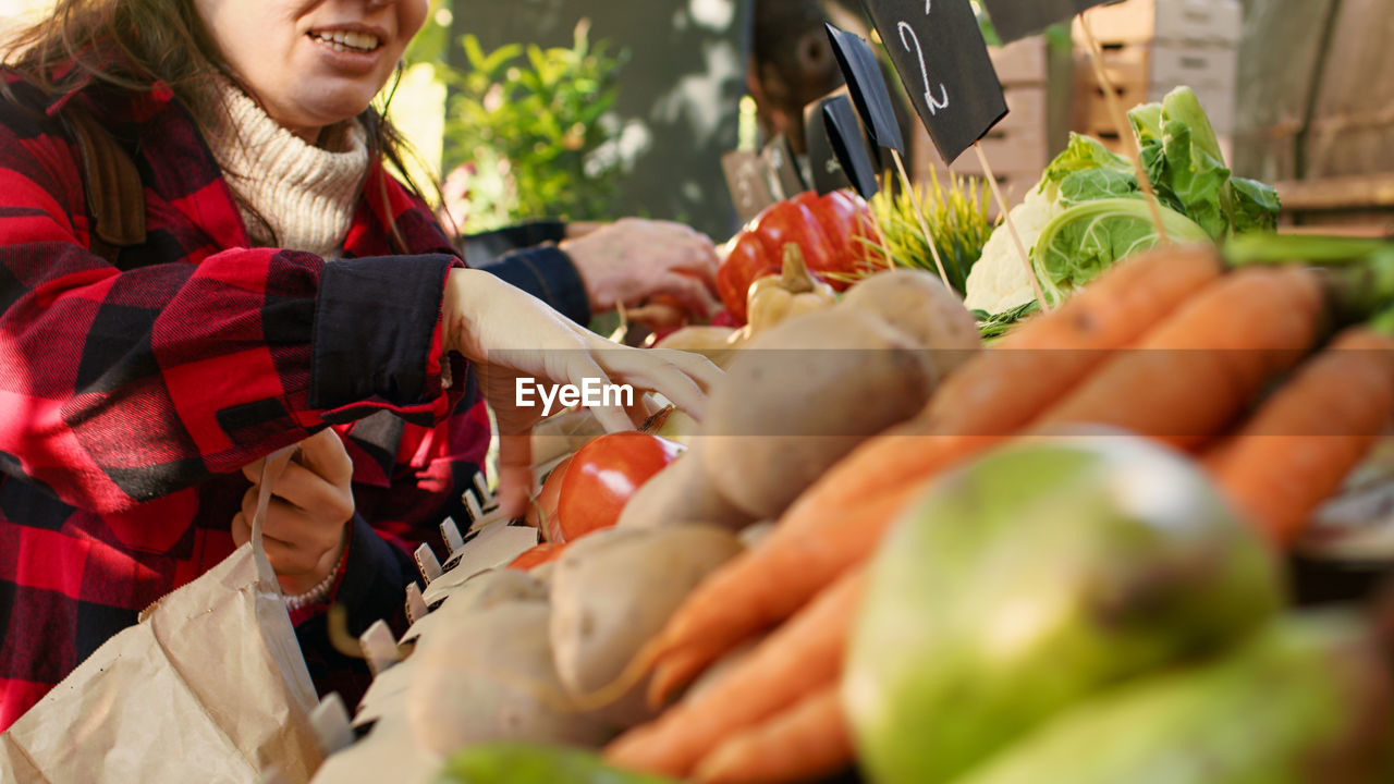 portrait of woman with vegetables for sale