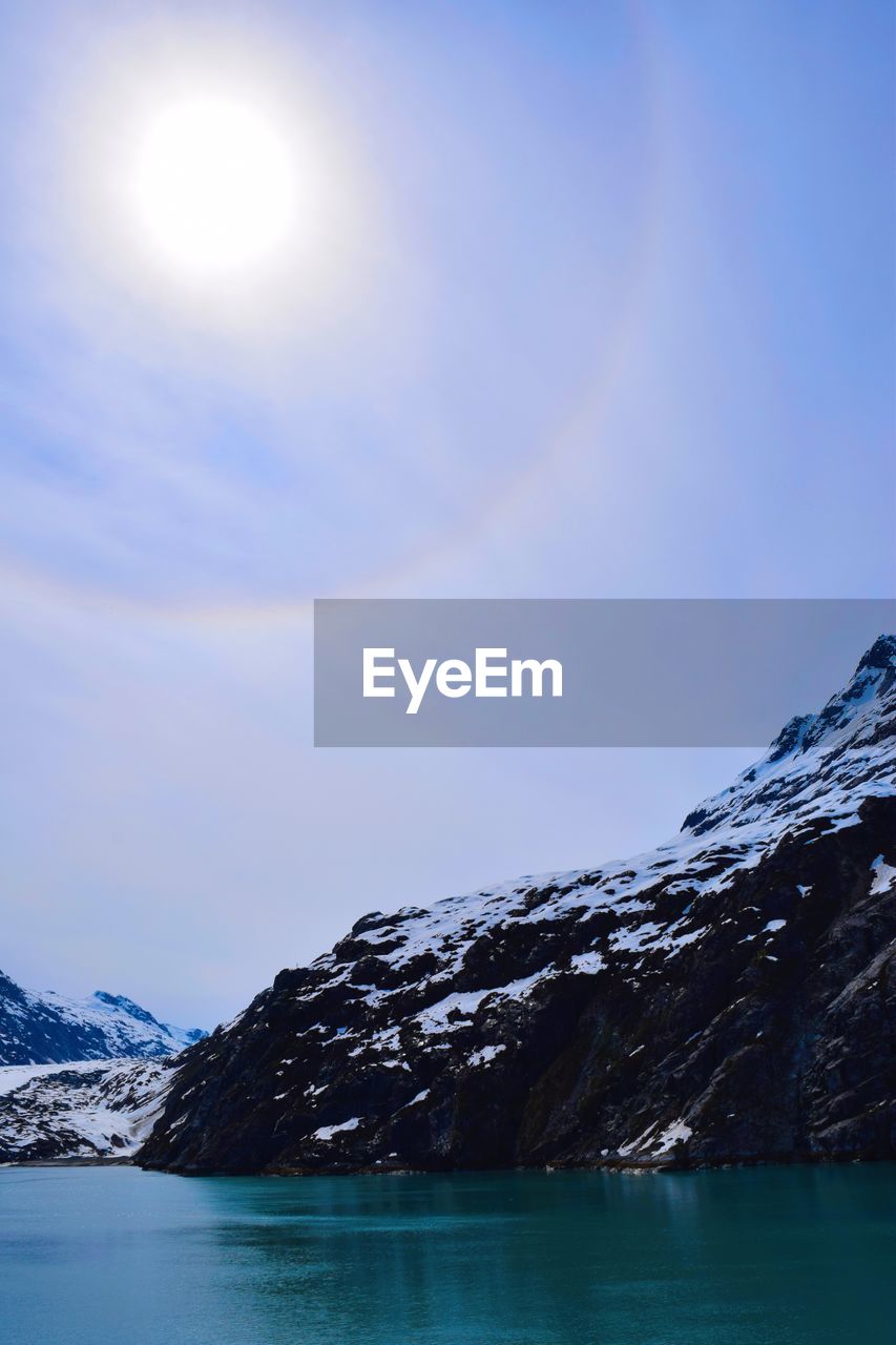 Scenic view of snow covered mountains against sky