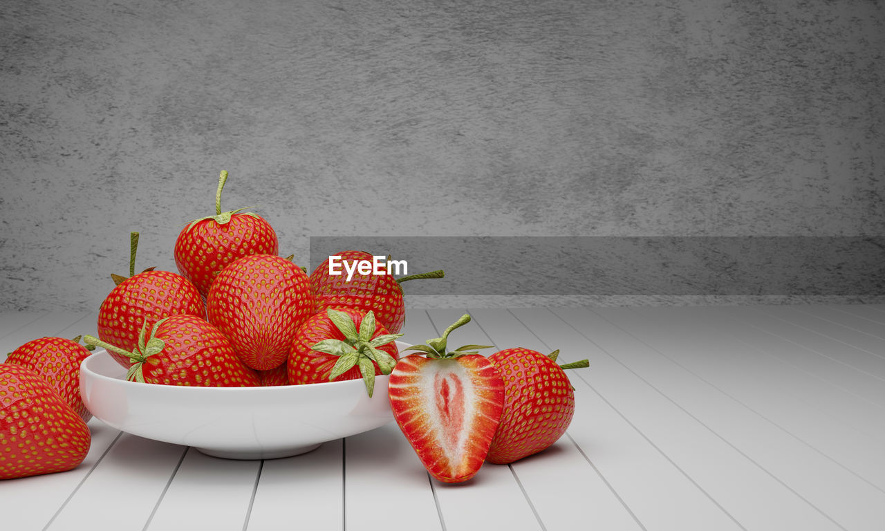 Close-up of strawberries on table against wall