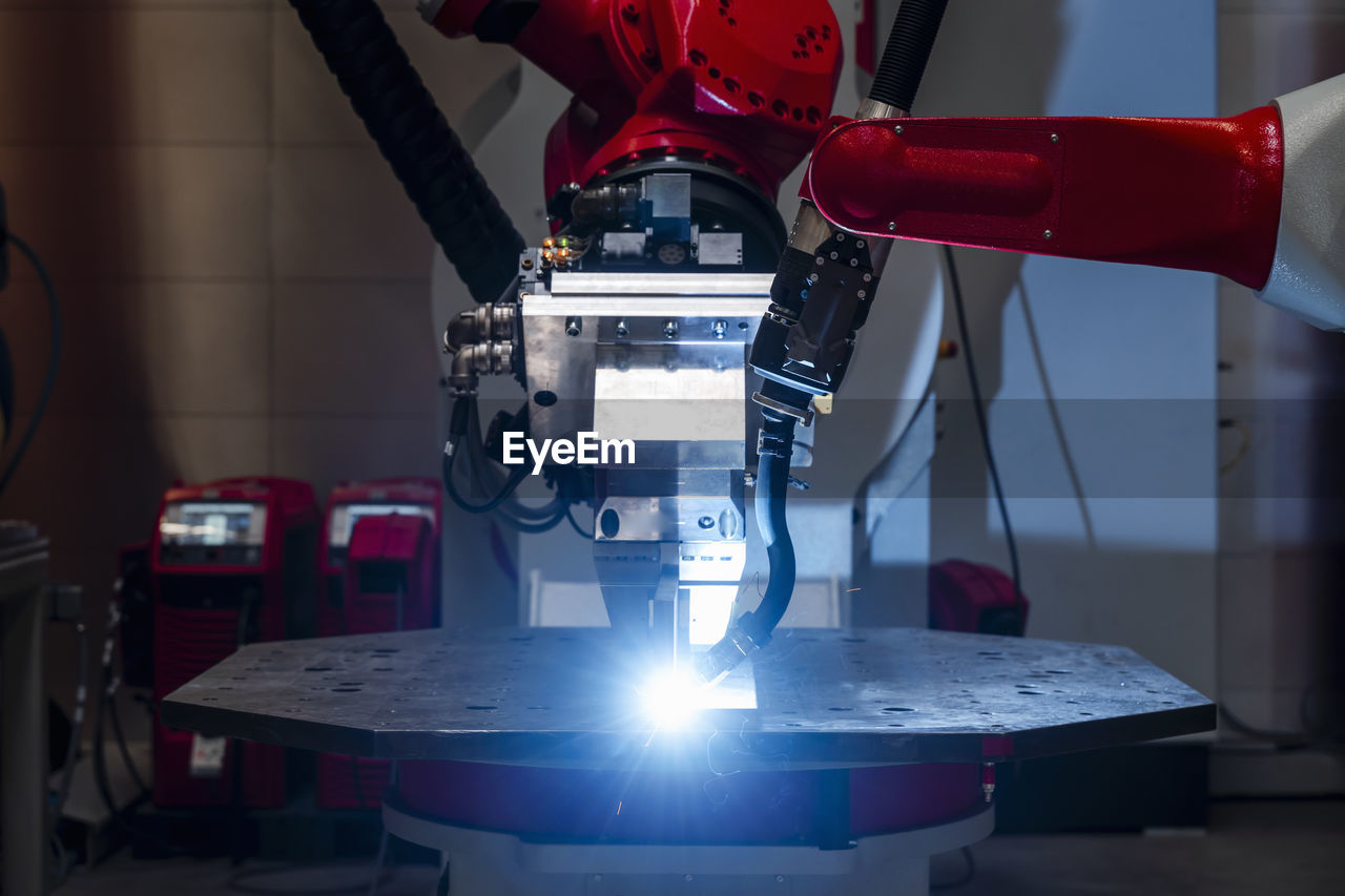 Close-up of automated robot welding metal in factory