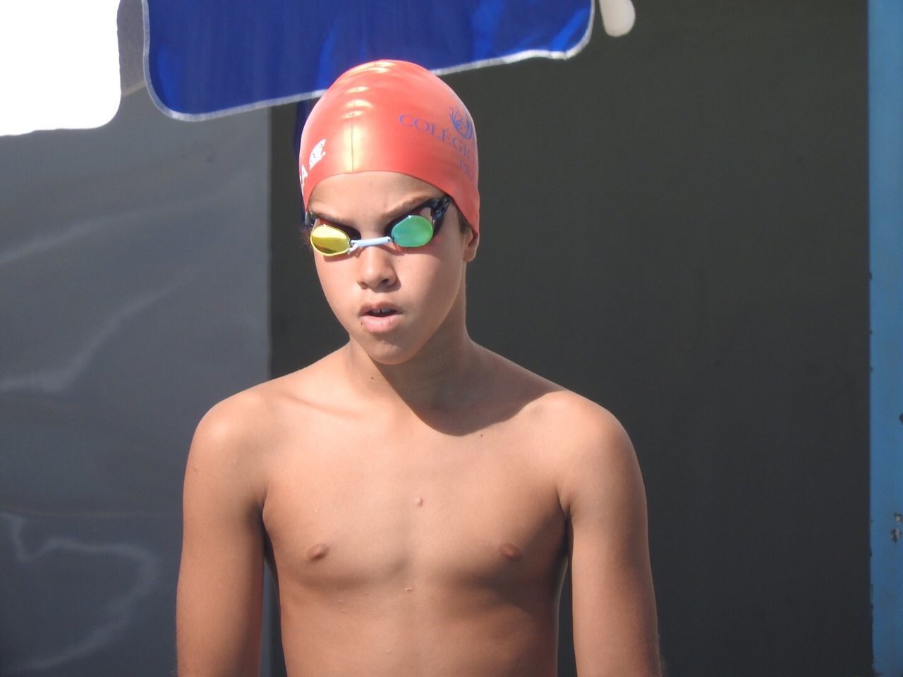 CLOSE-UP OF SHIRTLESS BOY WEARING HAT