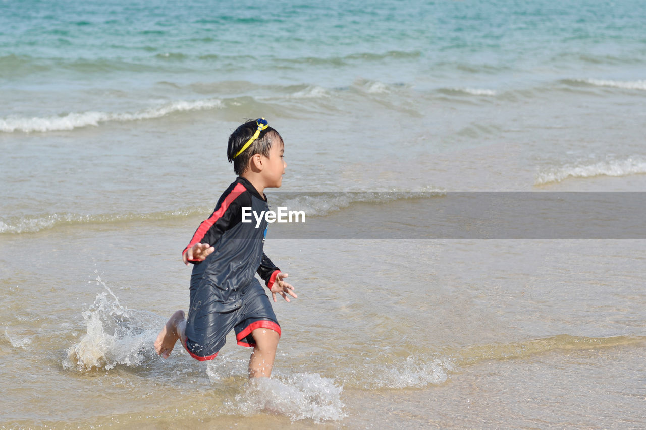 Full length of boy at beach