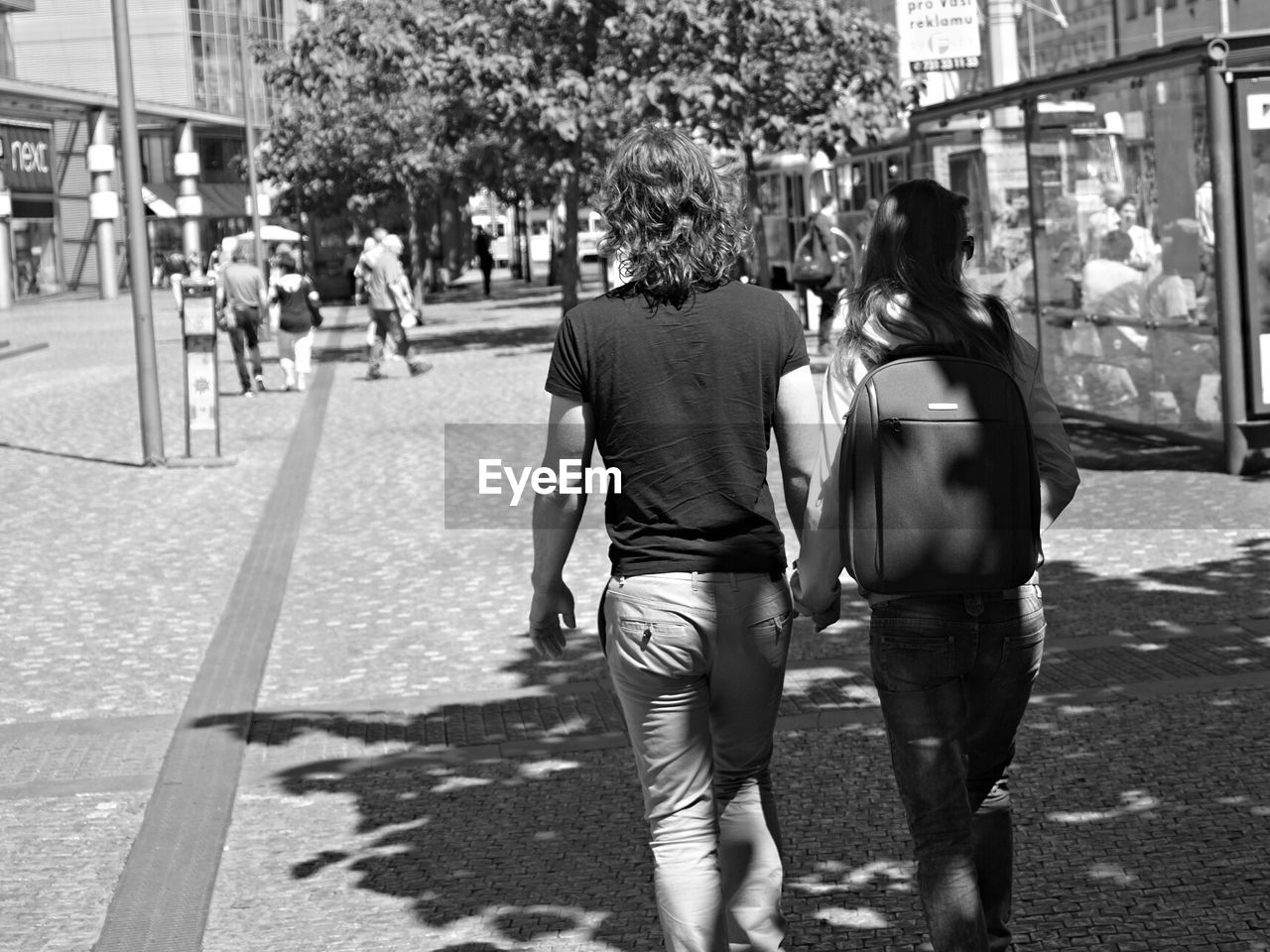 WOMAN STANDING ON CITY STREET