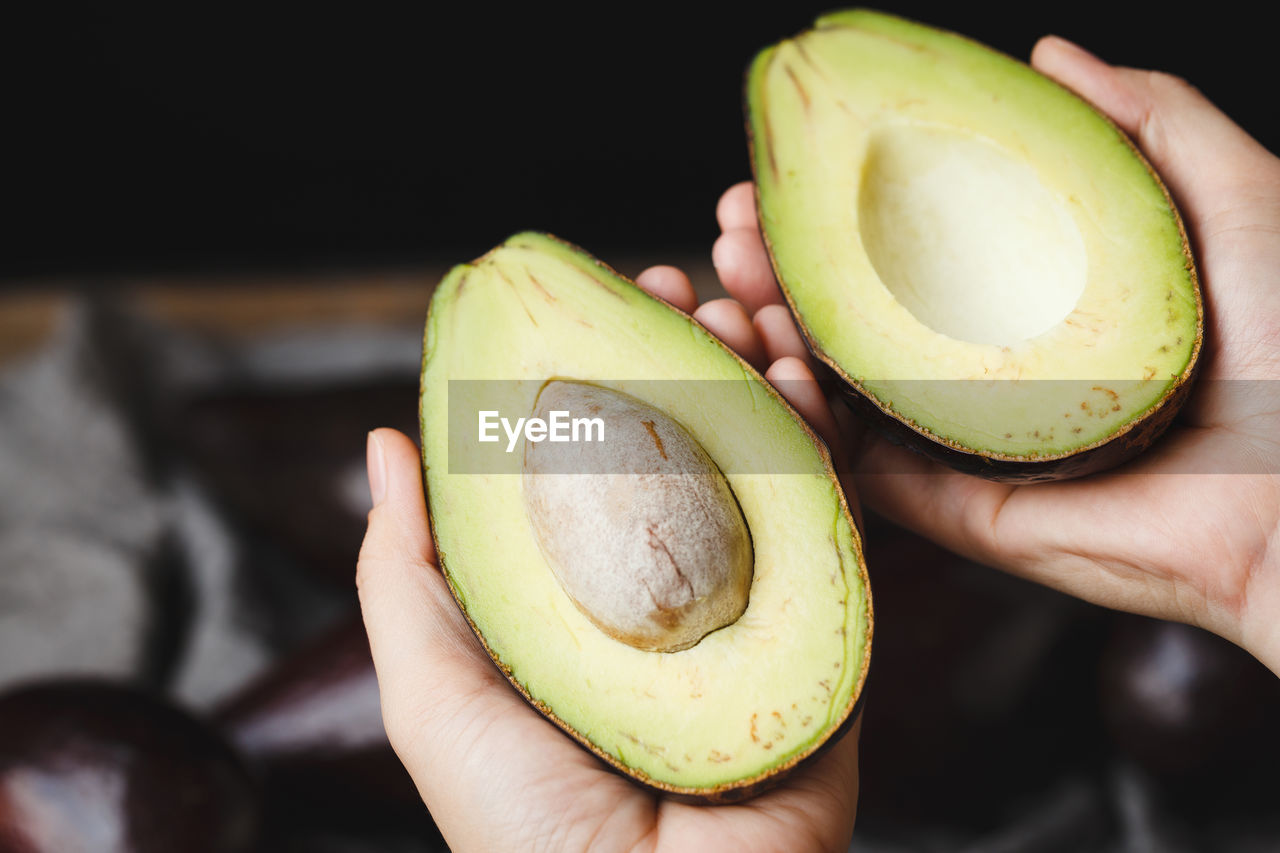 Close-up of hand holding avocado