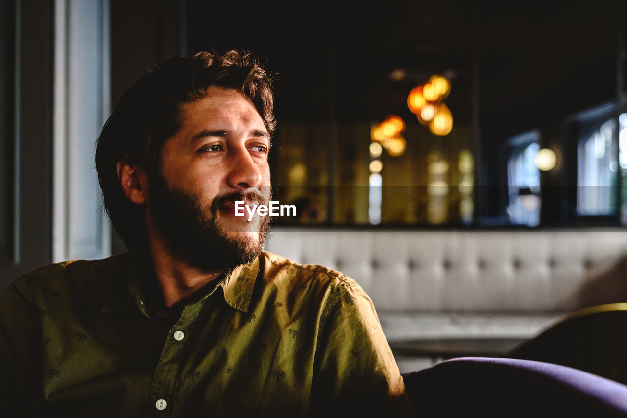 Man looking away while sitting on seat