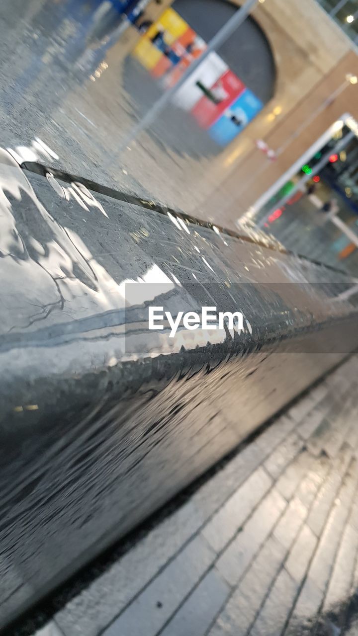 HIGH ANGLE VIEW OF CAR ON TABLE BY GLASS