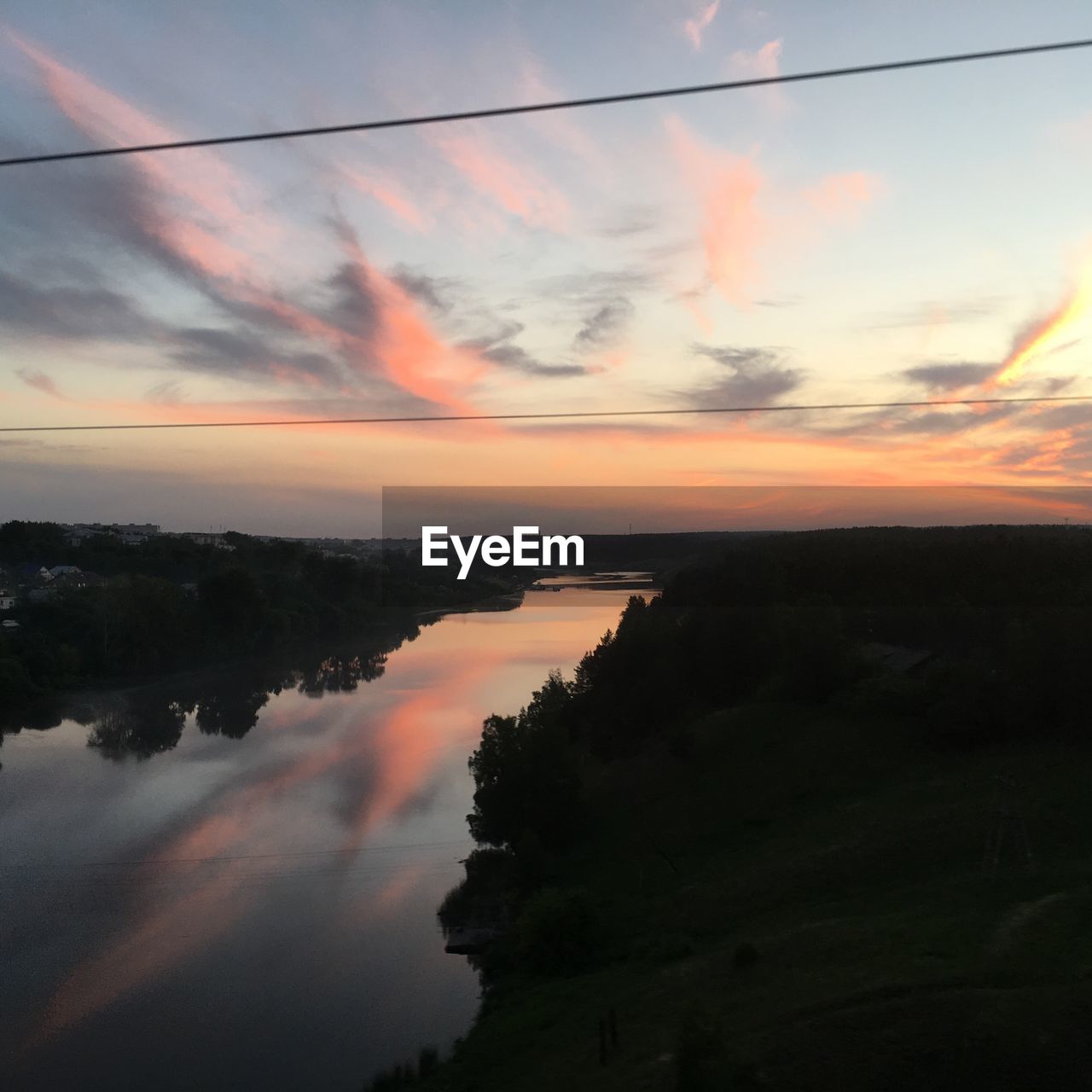 Scenic view of lake against sky at sunset