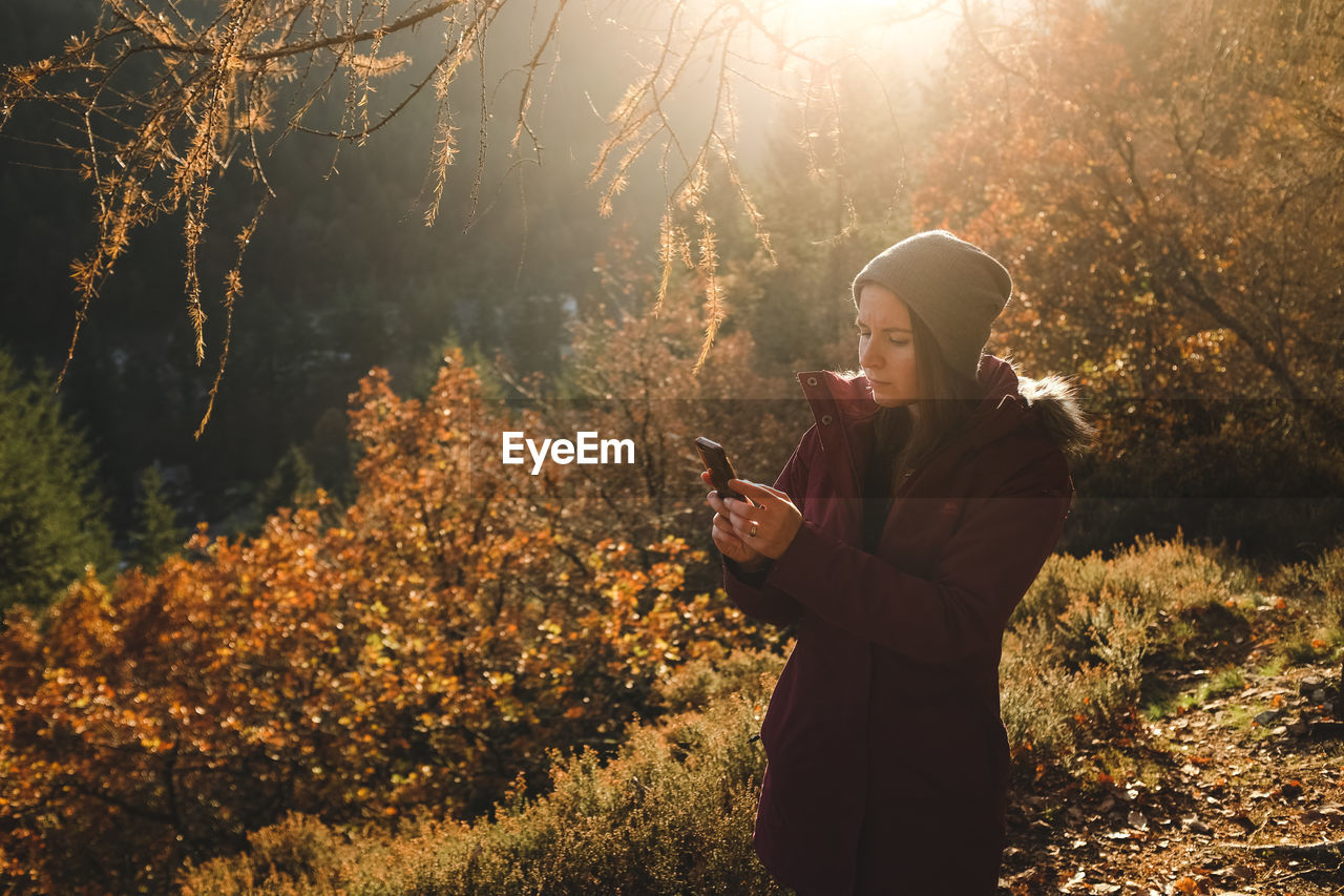 Woman using phone outdoors