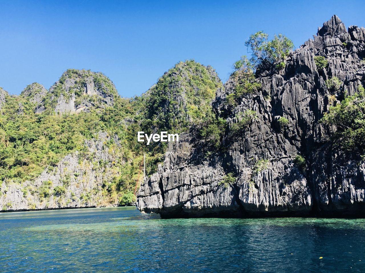 Scenic view of sea against clear blue sky