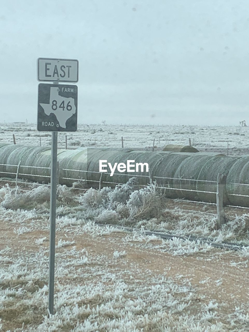 ROAD SIGN ON SNOW COVERED LAND