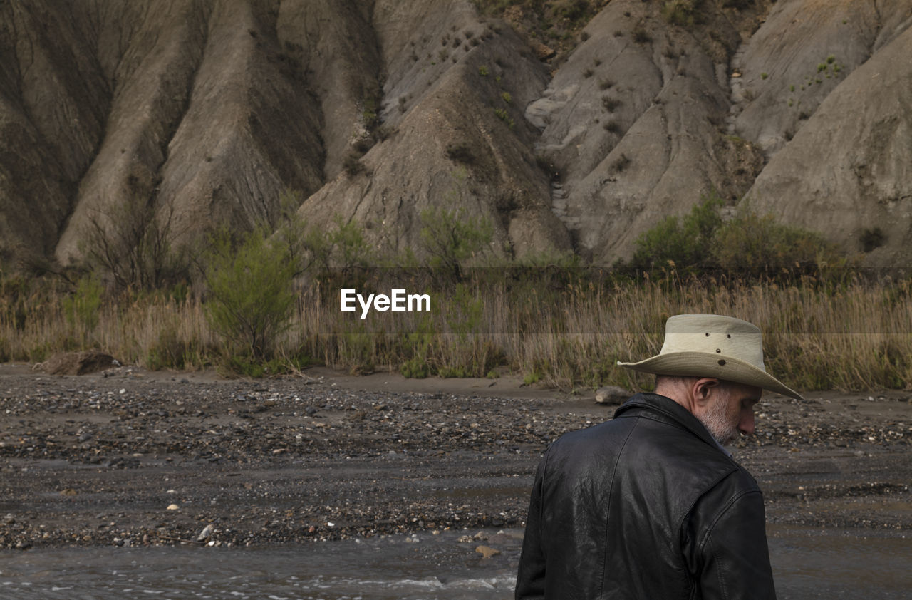 Adult man in cowboy hat in oasis of desert. almeria, spain