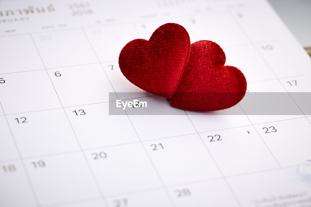 Close-up of red heart shapes on calendar