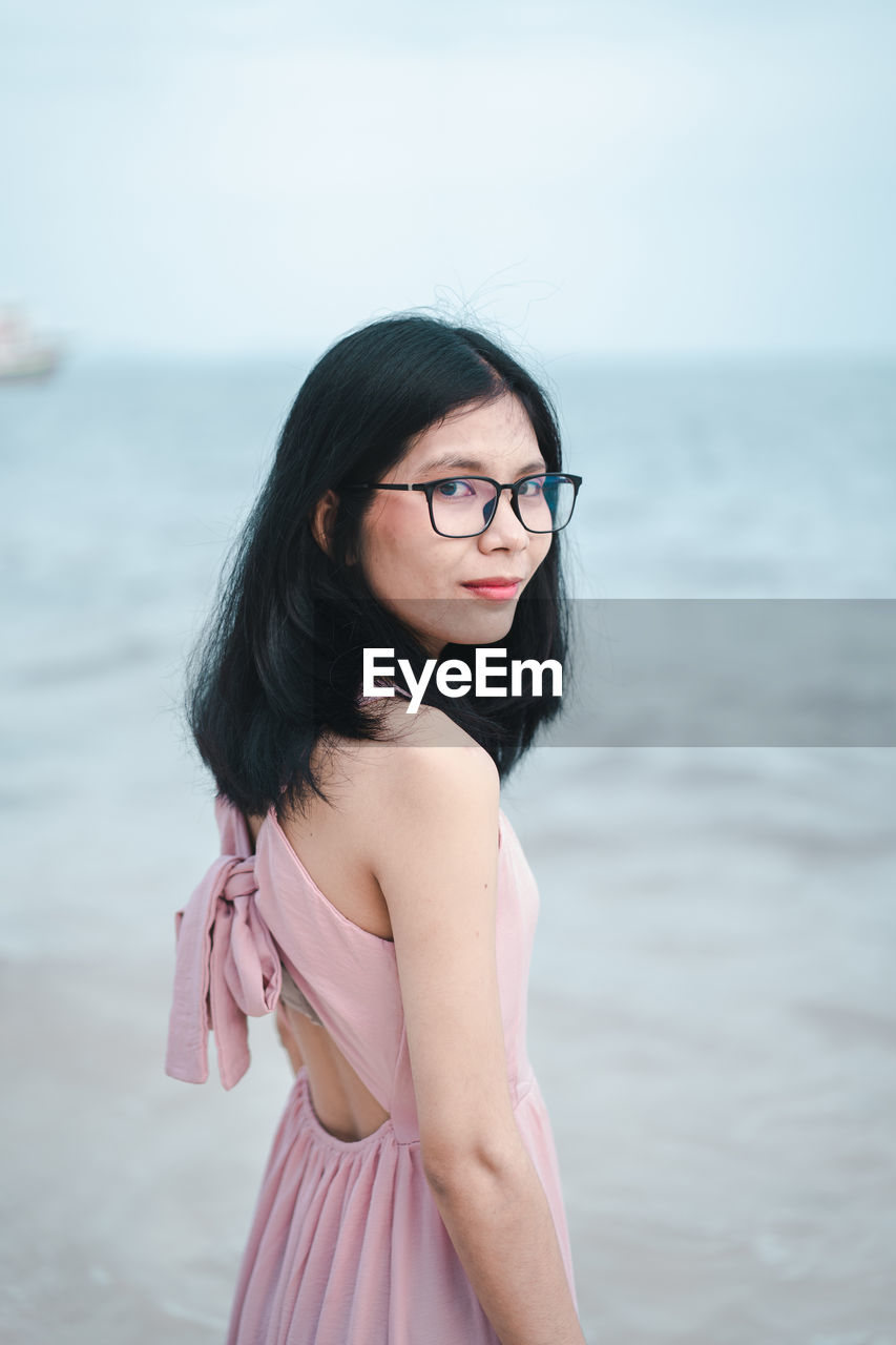 Young woman standing in sea