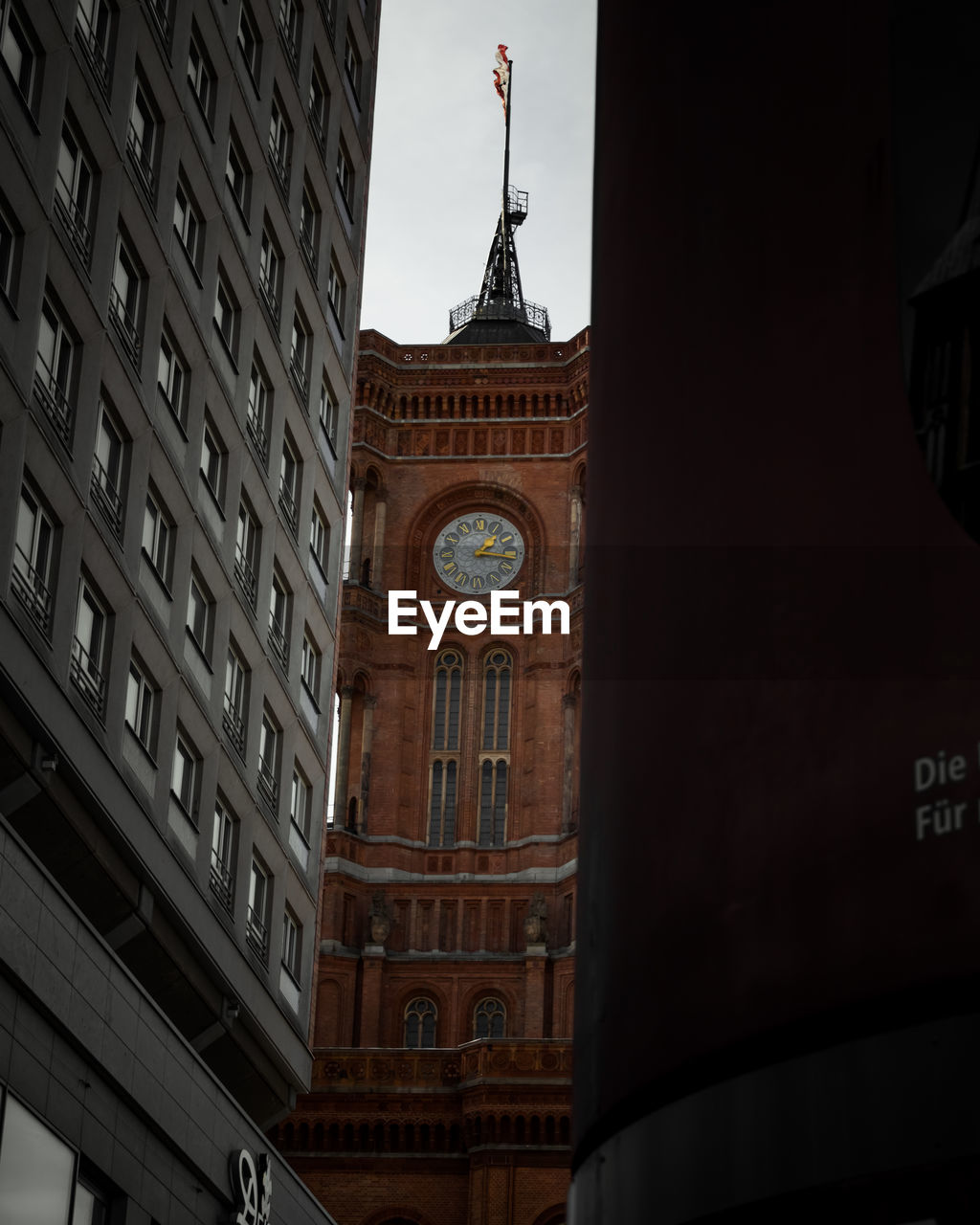 LOW ANGLE VIEW OF CLOCK TOWER AGAINST BUILDINGS IN CITY