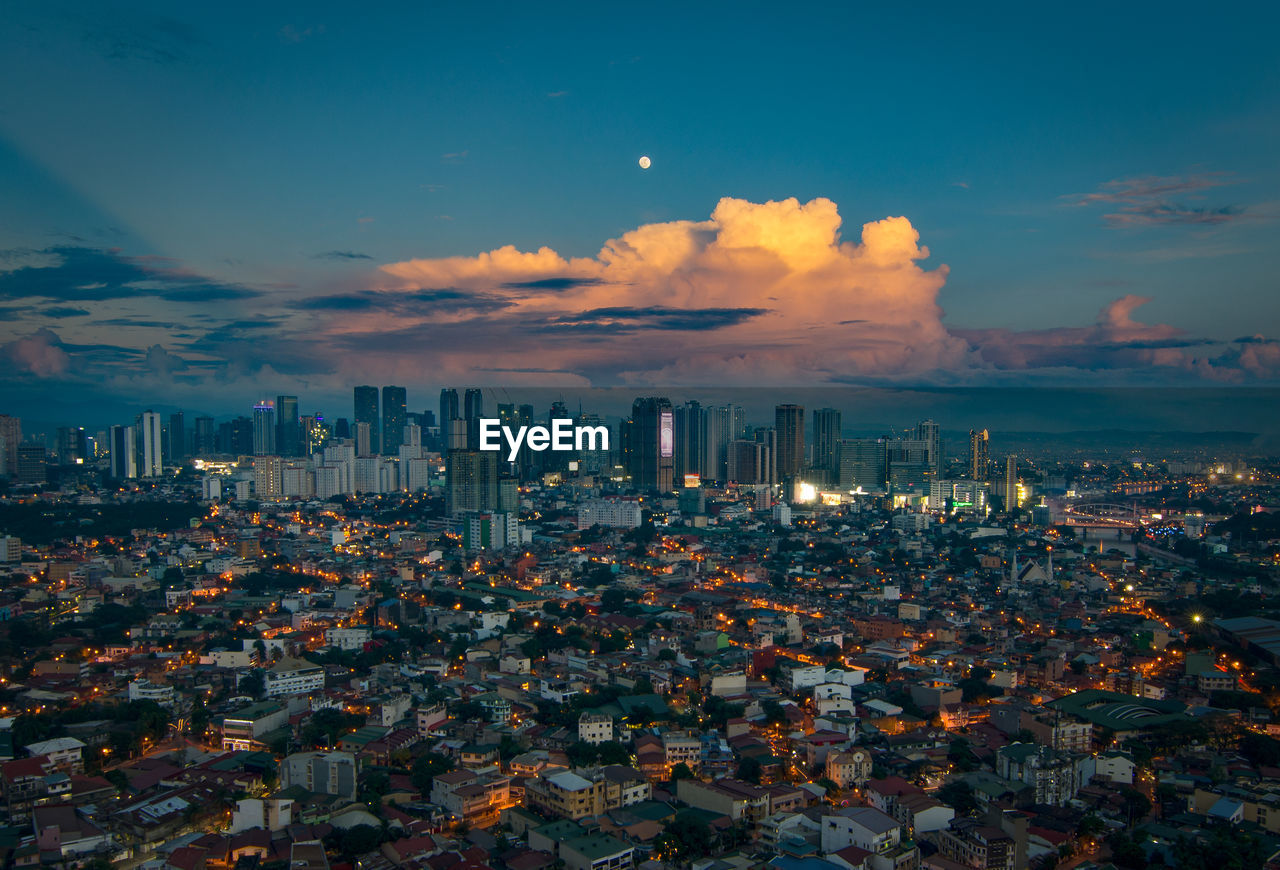 Aerial view of cityscape against sky during sunset