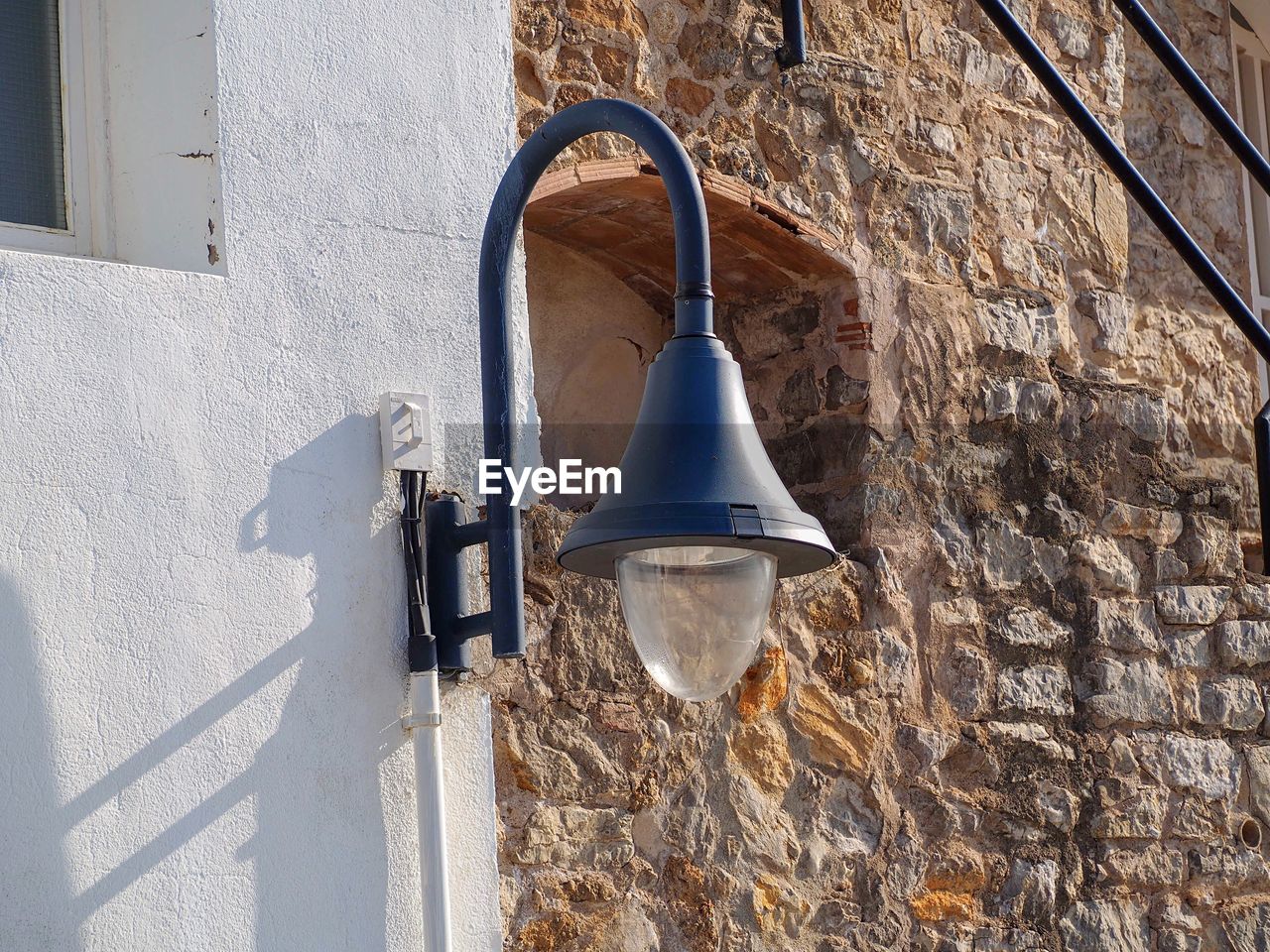 LOW ANGLE VIEW OF LAMP ON WALL