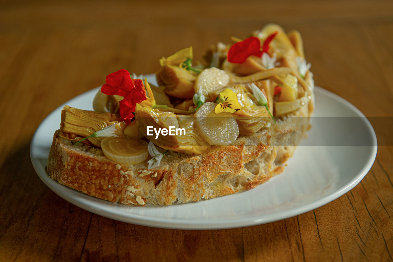 High angle view of toast with marinated in plate on table