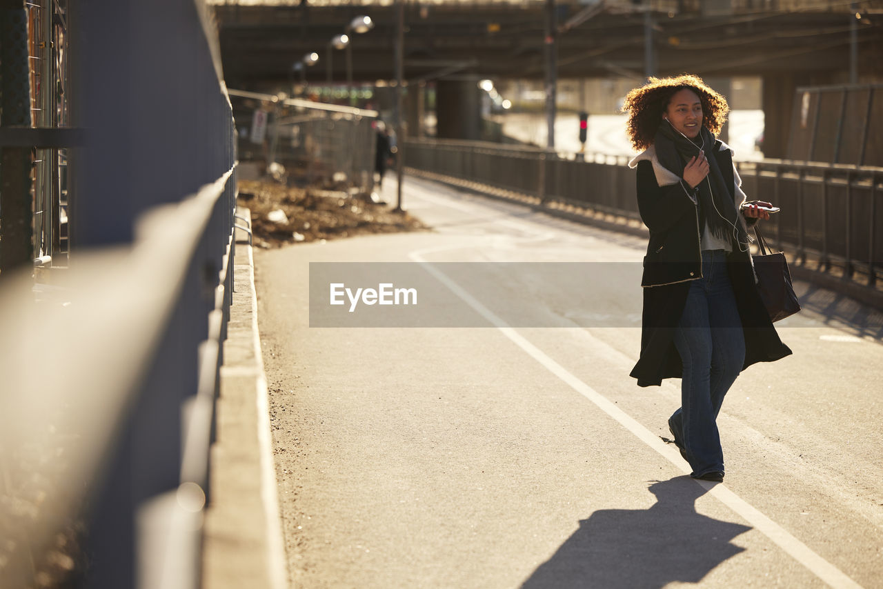 Young woman walking on street