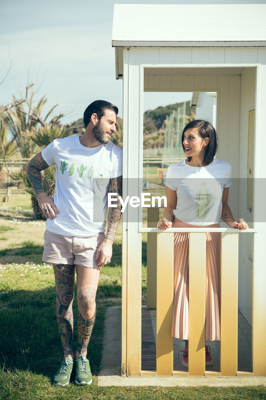 Portrait of hipster couple on front porch