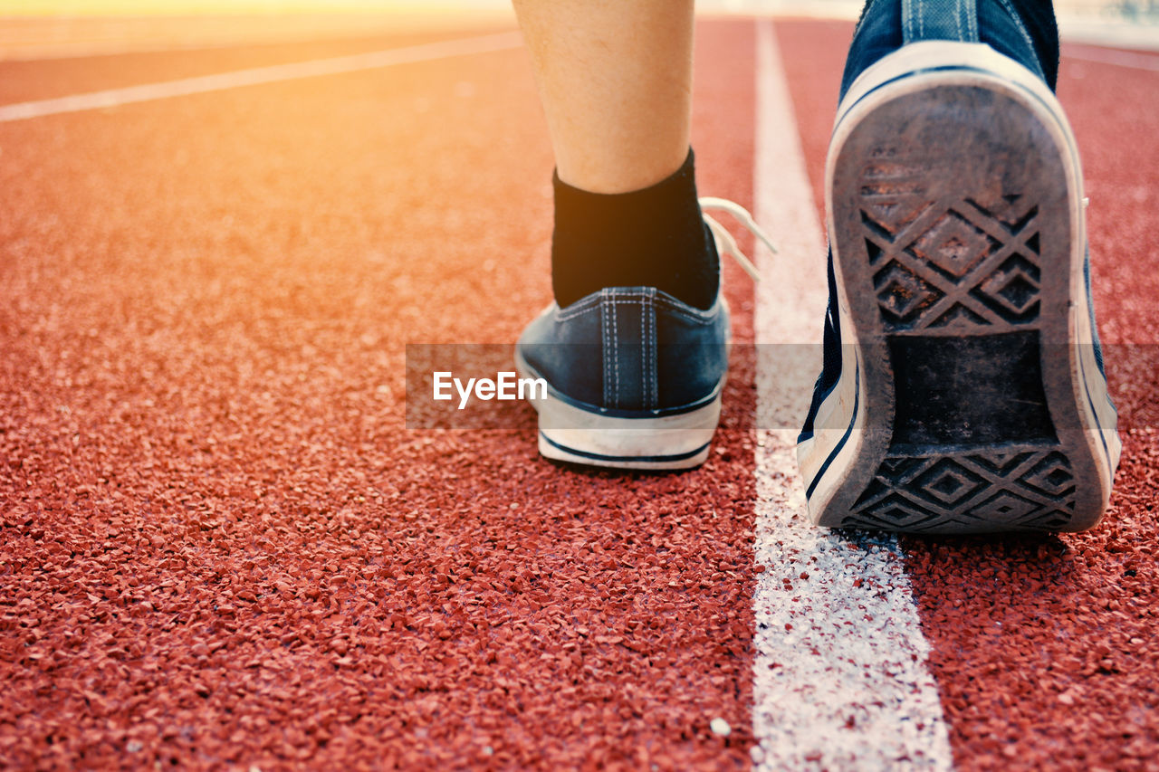 Low section of athlete at running track