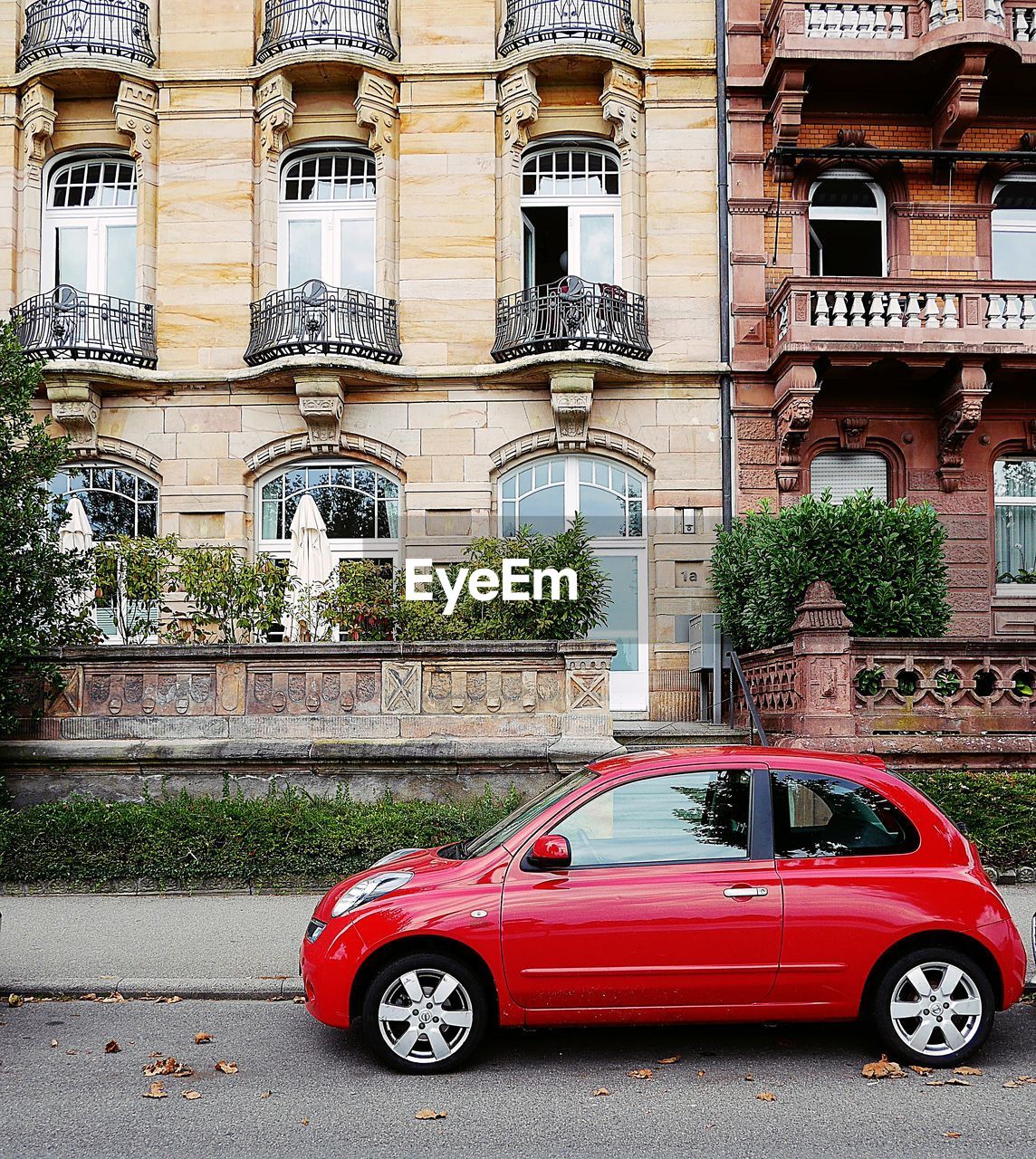 CAR ON ROAD AGAINST BUILDING