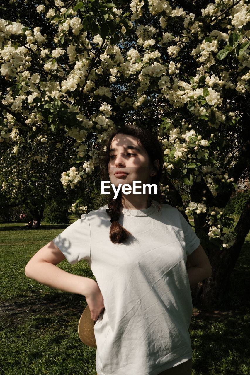 Portrait of woman standing against plants