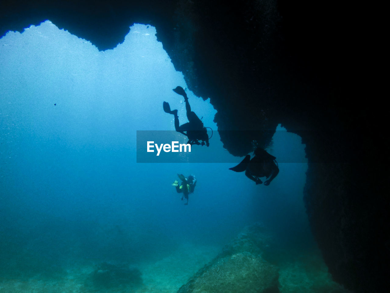 Low angle view of people swimming in sea