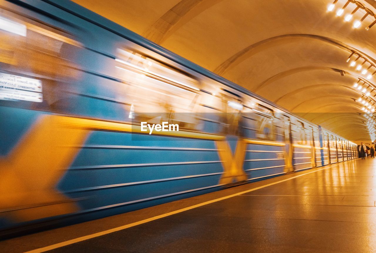 TRAIN AT ILLUMINATED SUBWAY STATION