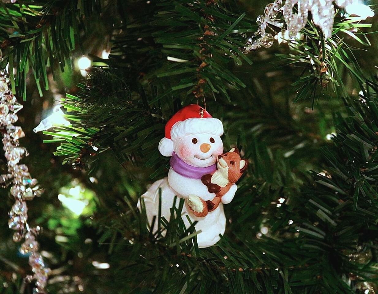 Close-up of figurines hanging on christmas tree
